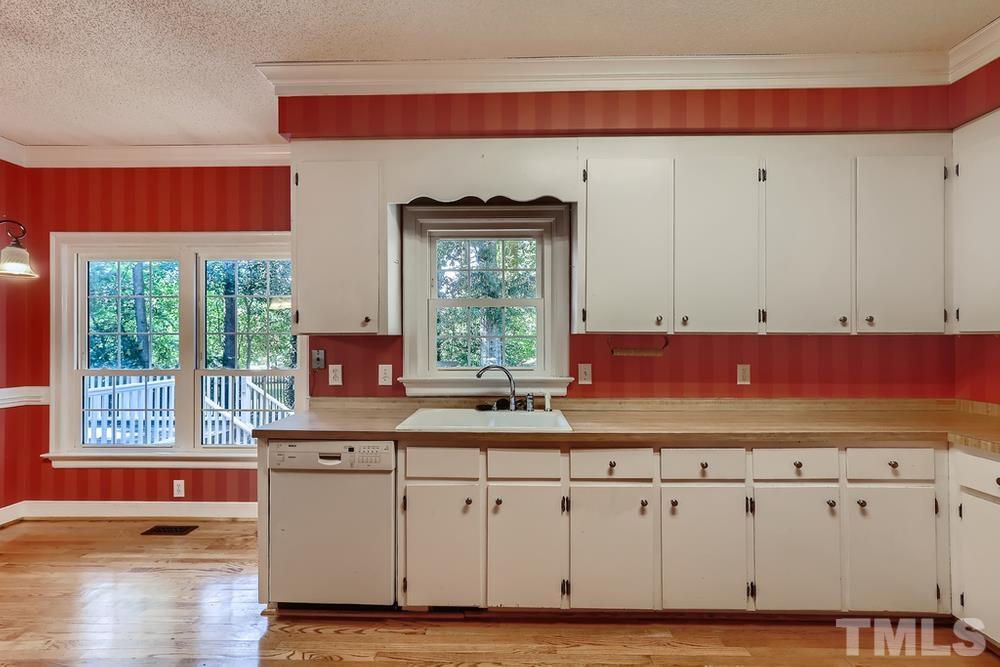 7301 Sandy Grove Court Raleigh, NC 27615 - Photo 9 of 28 a kitchen with a cabinets and window