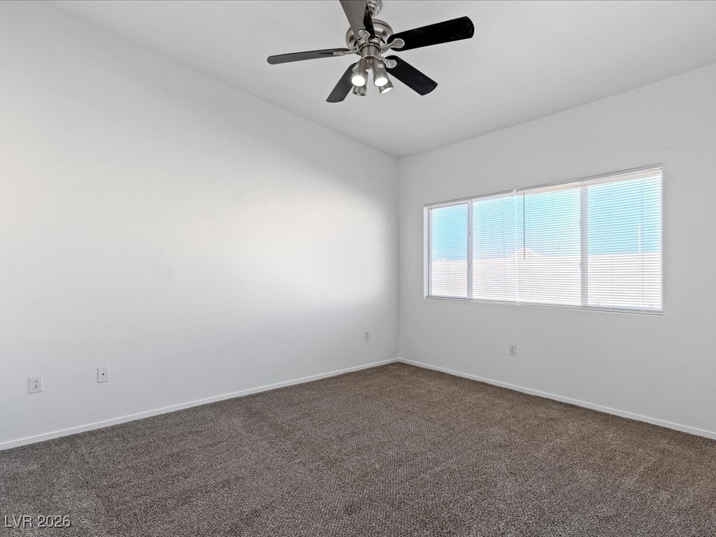 8725 West Flamingo Road, Unit 235 Las Vegas, NV 89147 - Photo 13 of 22 Spare room with dark carpet and ceiling fan