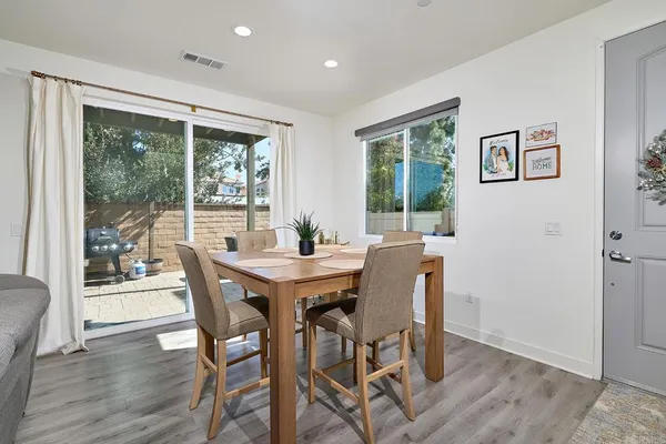 a view of a dining room with furniture window and wooden floor