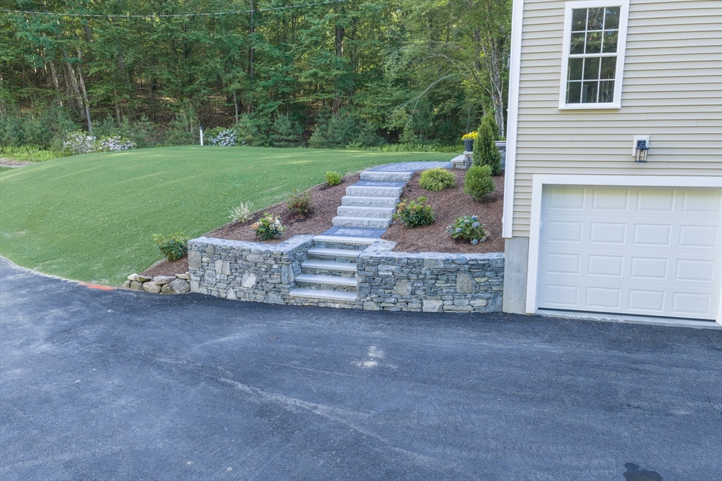 41 Martin Road Douglas, MA 01516 - Photo 6 of 40 a view of a house with a yard and a garage
