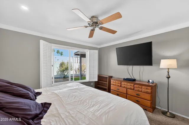 a bedroom with a bed and a flat screen tv