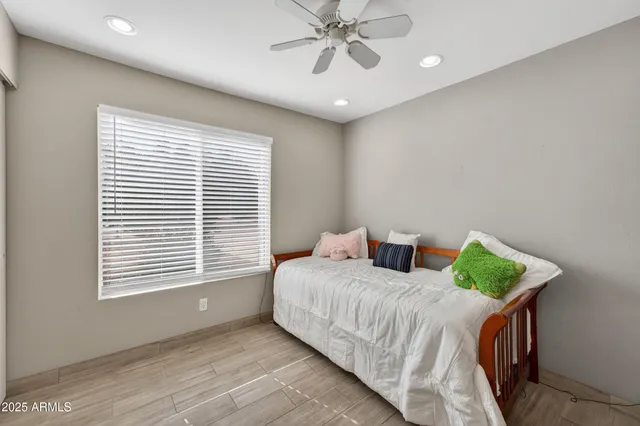 a bedroom with a bed and a window