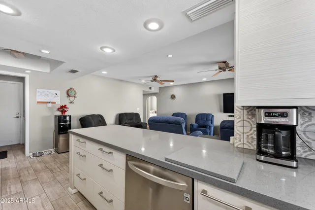 a kitchen with a refrigerator and a fireplace