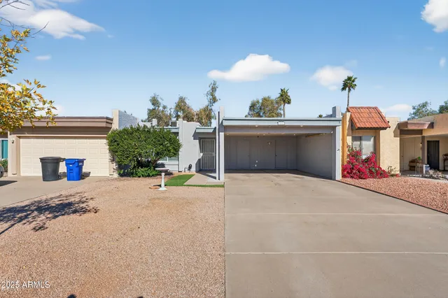a view of a house with a patio and a garage