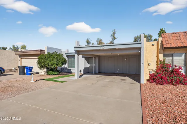 a view of a house with a yard and a garage