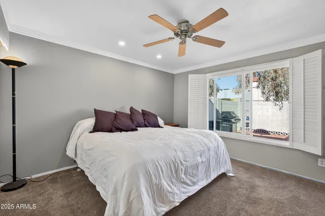 a bedroom with a large bed and a large window