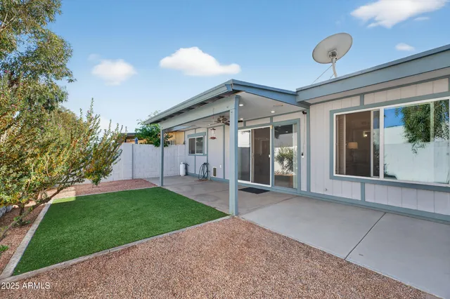 a view of a house with a yard and porch