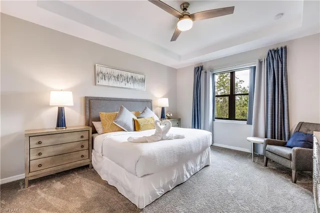 a bedroom with bed and a large window