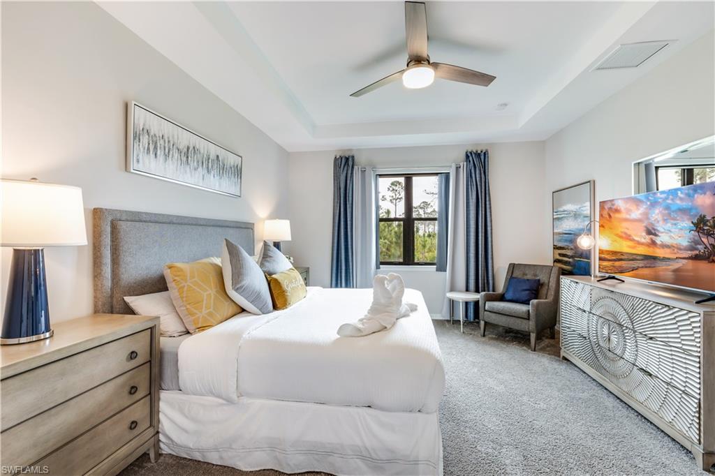 16216 Palmetto Street Babcock Ranch, FL 33982 - Photo 15 of 16 a bedroom with a bed and a chandelier