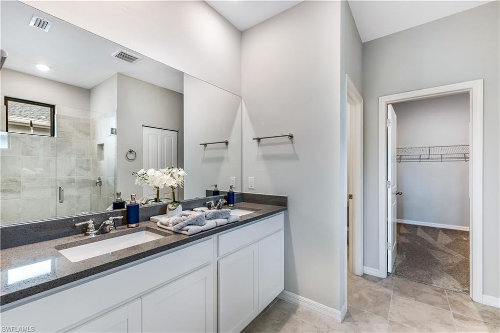 16216 Palmetto Street Babcock Ranch, FL 33982 - Photo 16 of 16 a bathroom with a sink and a mirror