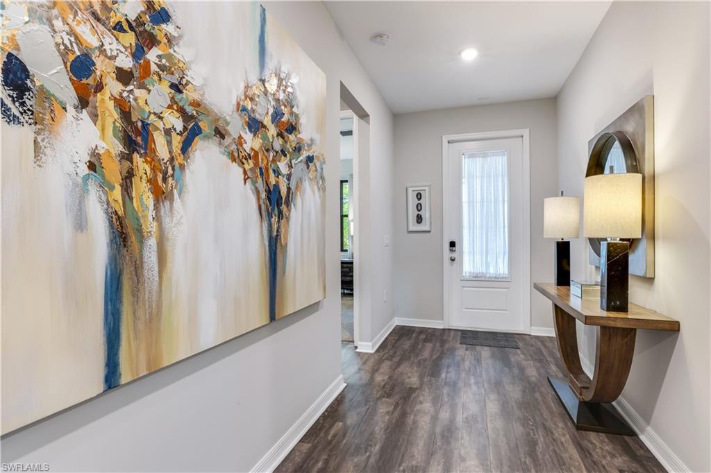 16216 Palmetto Street Babcock Ranch, FL 33982 - Photo 3 of 16 a view of a hallway with wooden floor and staircase