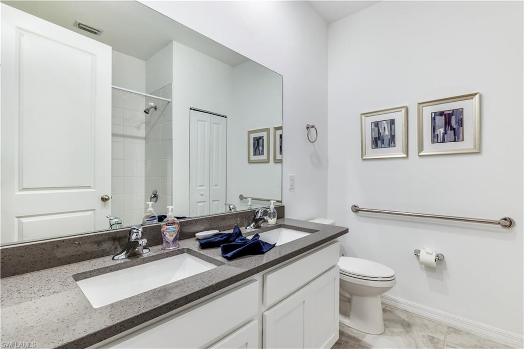 16216 Palmetto Street Babcock Ranch, FL 33982 - Photo 5 of 16 a bathroom with a sink and a mirror with toilet