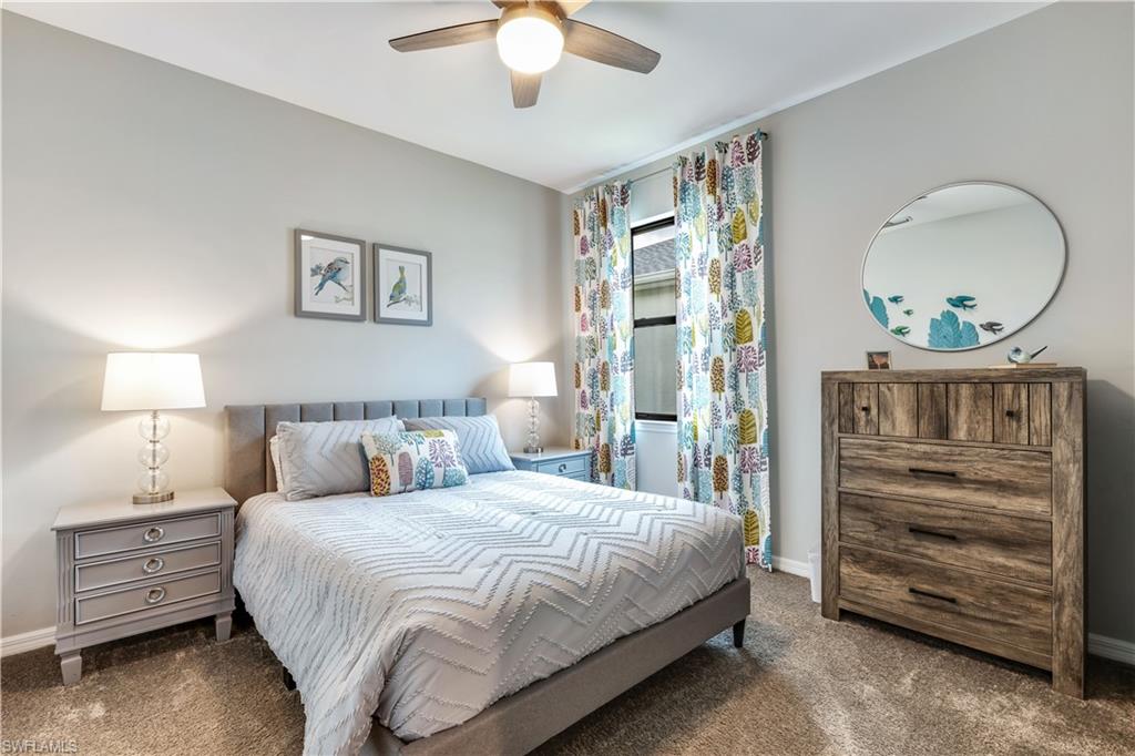 16216 Palmetto Street Babcock Ranch, FL 33982 - Photo 6 of 16 a bedroom with a bed and a chandelier