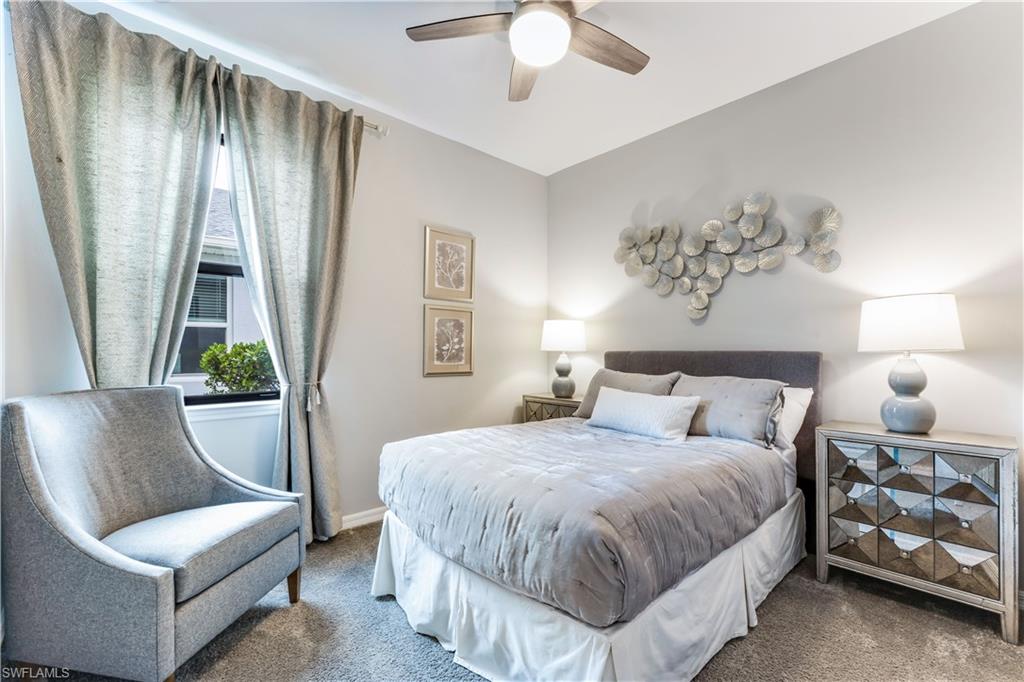 16216 Palmetto Street Babcock Ranch, FL 33982 - Photo 7 of 16 a bedroom with a bed and a chandelier