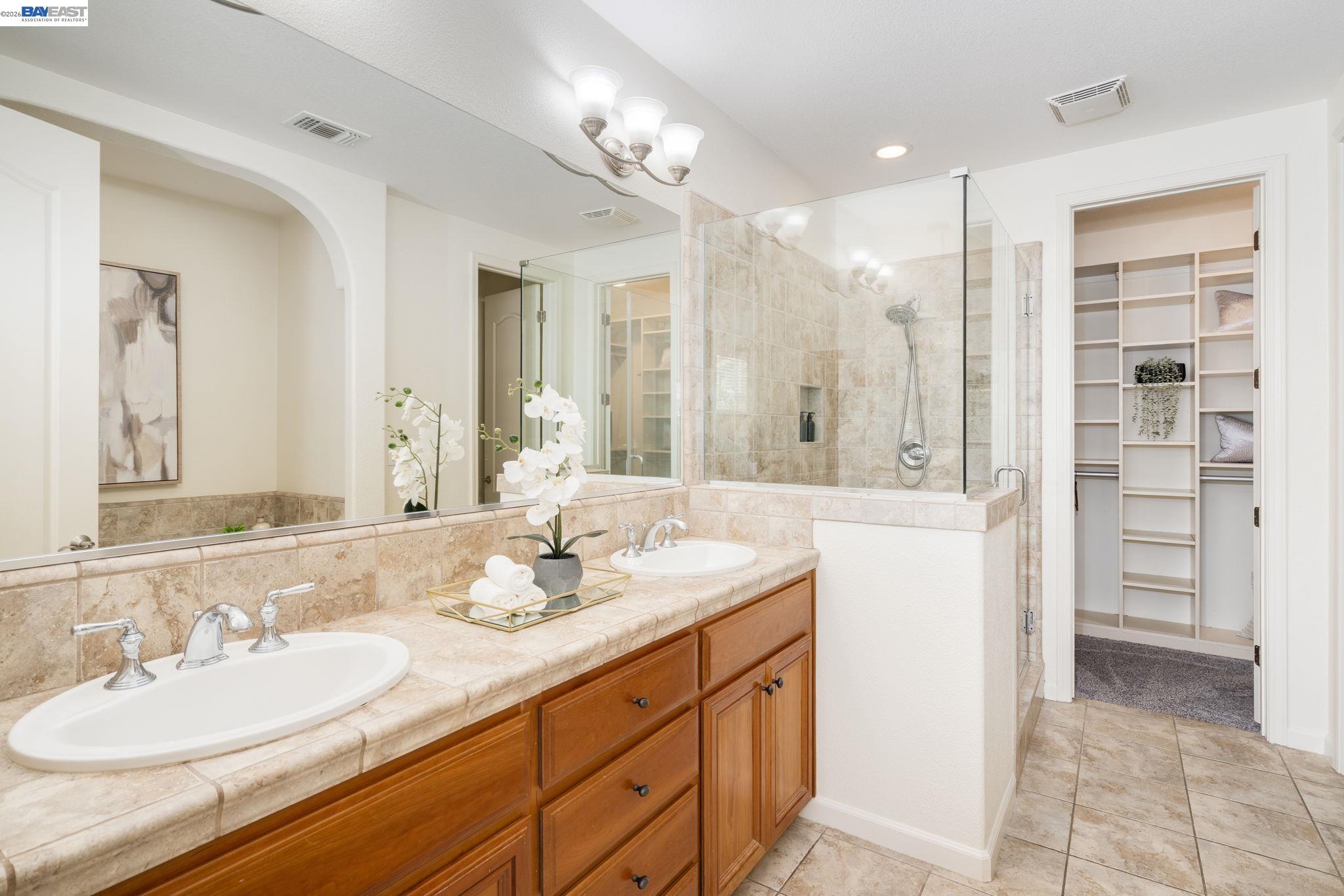 4653 Rimini Court Dublin, CA 94568 - Photo 27 of 44 a spacious bathroom with a double vanity sink mirror and double