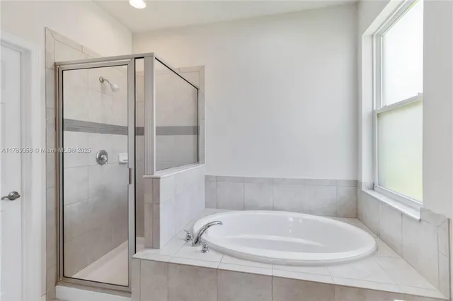 a bathroom with a tub and shower