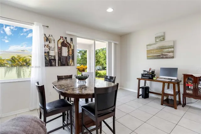 a view of a dining room with furniture and a potted plant