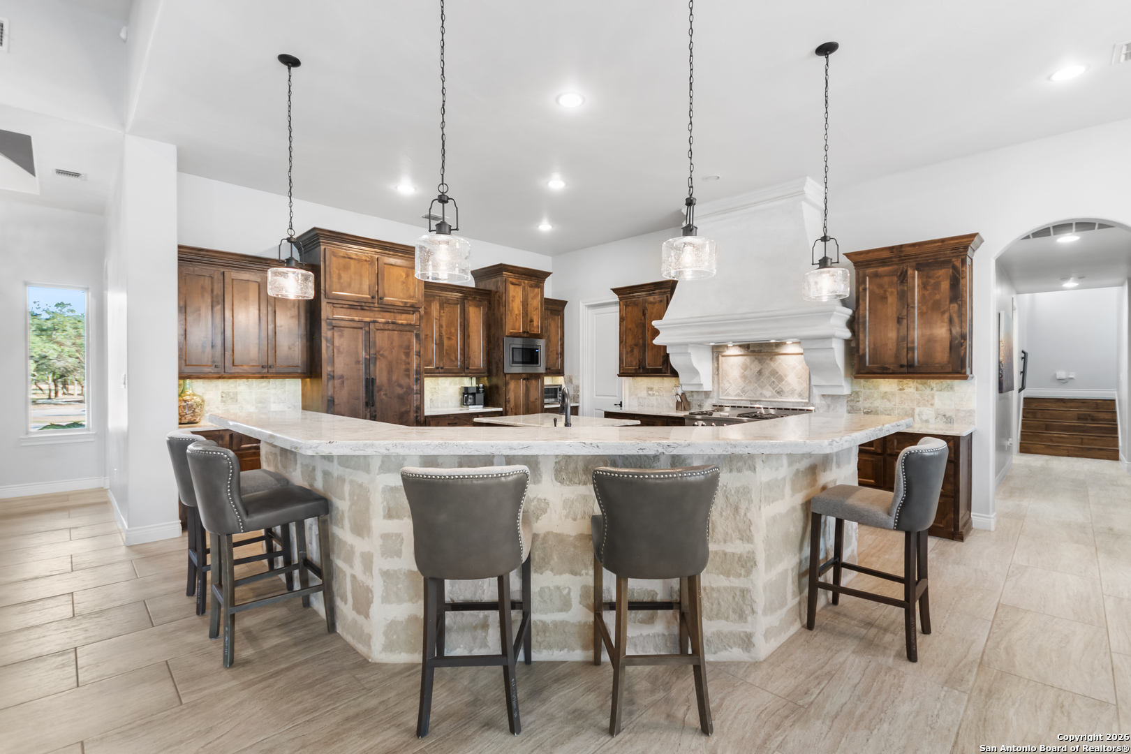 9 Ranch Brook Road Boerne, TX 78015 - Photo 11 of 59 a kitchen with stainless steel appliances kitchen island wooden cabinets refrigerator dining table and chairs