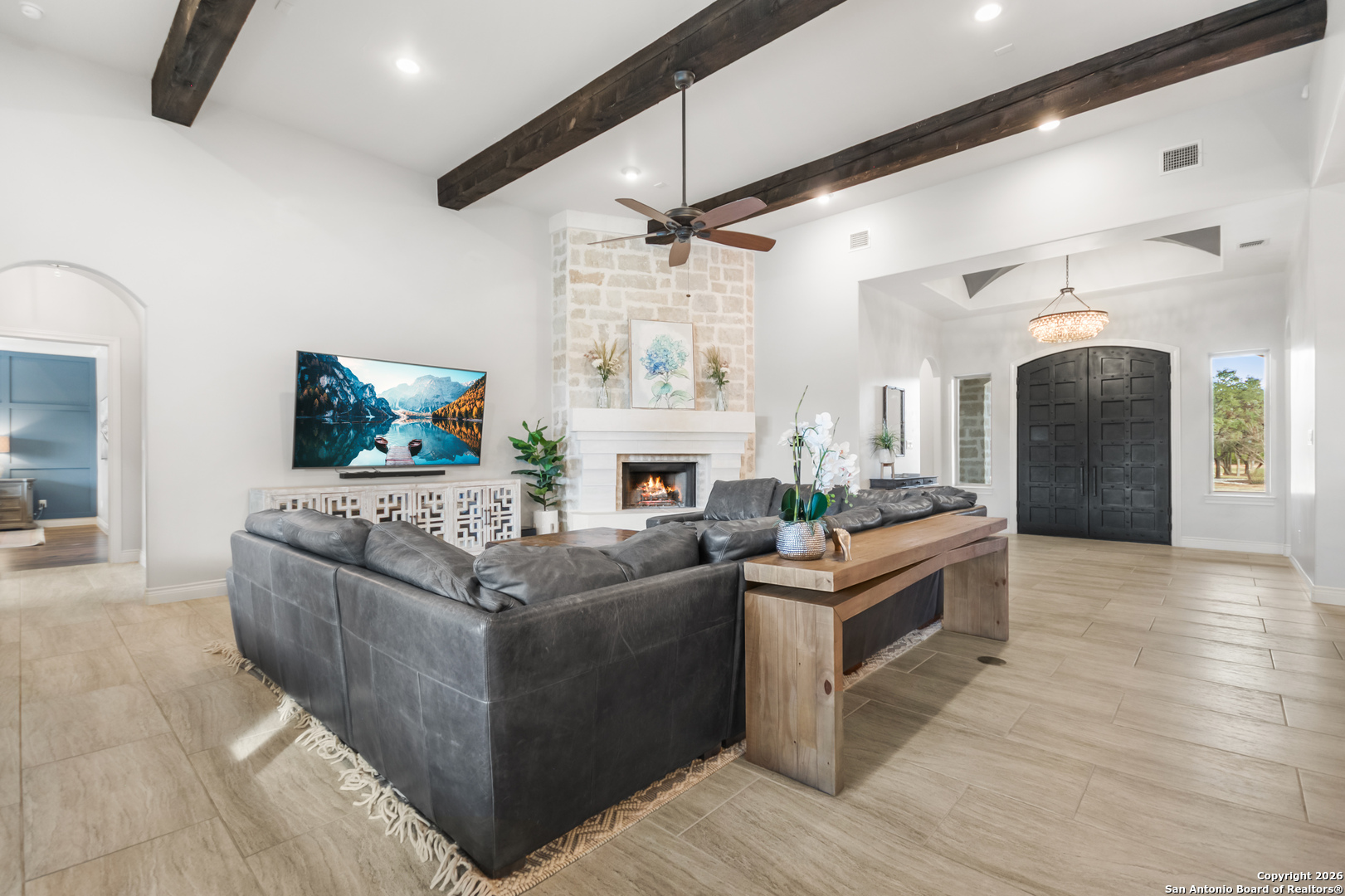 9 Ranch Brook Road Boerne, TX 78015 - Photo 16 of 59 a living room with furniture a fireplace and a flat screen tv