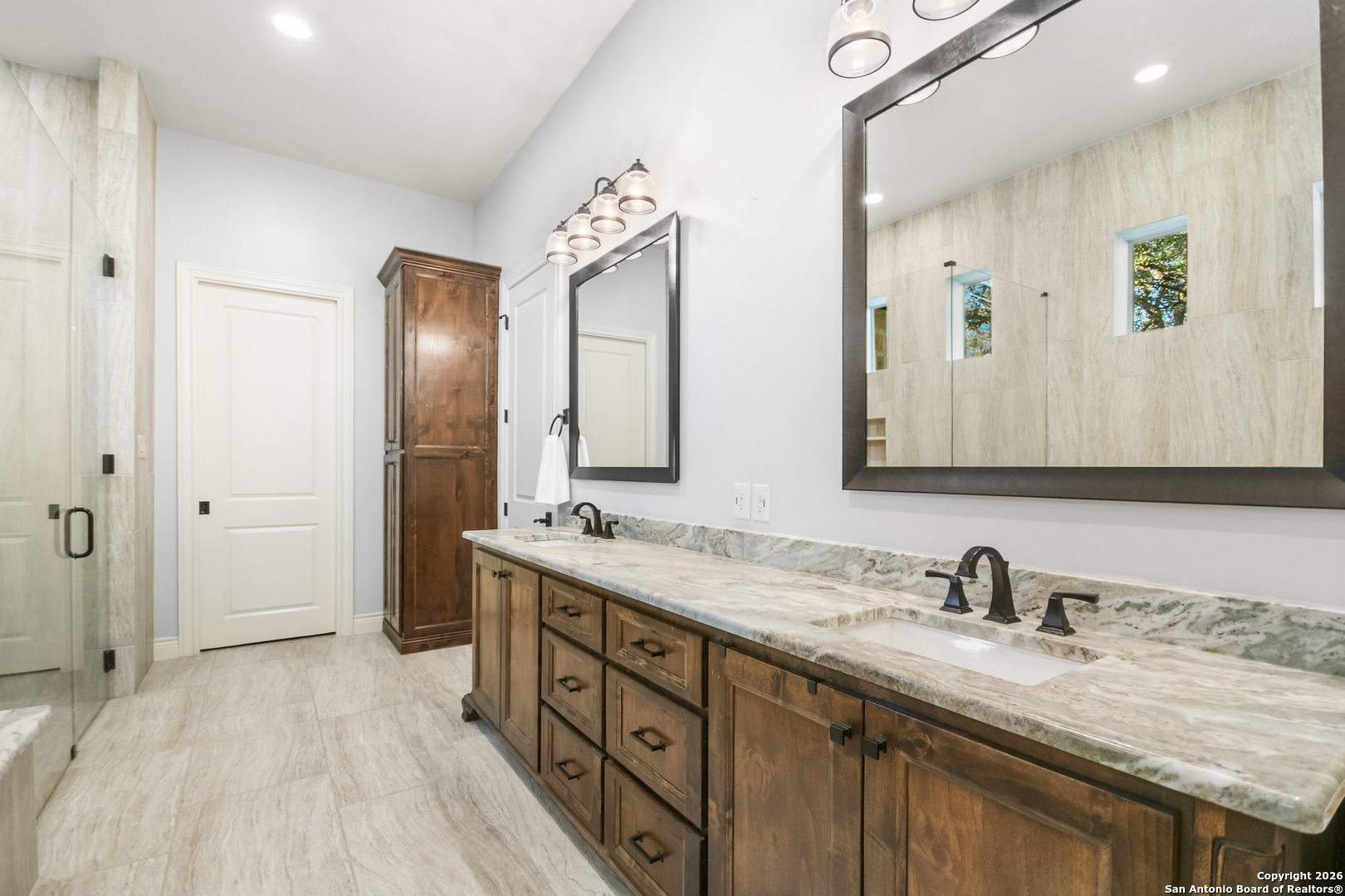 9 Ranch Brook Road Boerne, TX 78015 - Photo 23 of 59 a bathroom with a granite countertop double vanity sink and a mirror