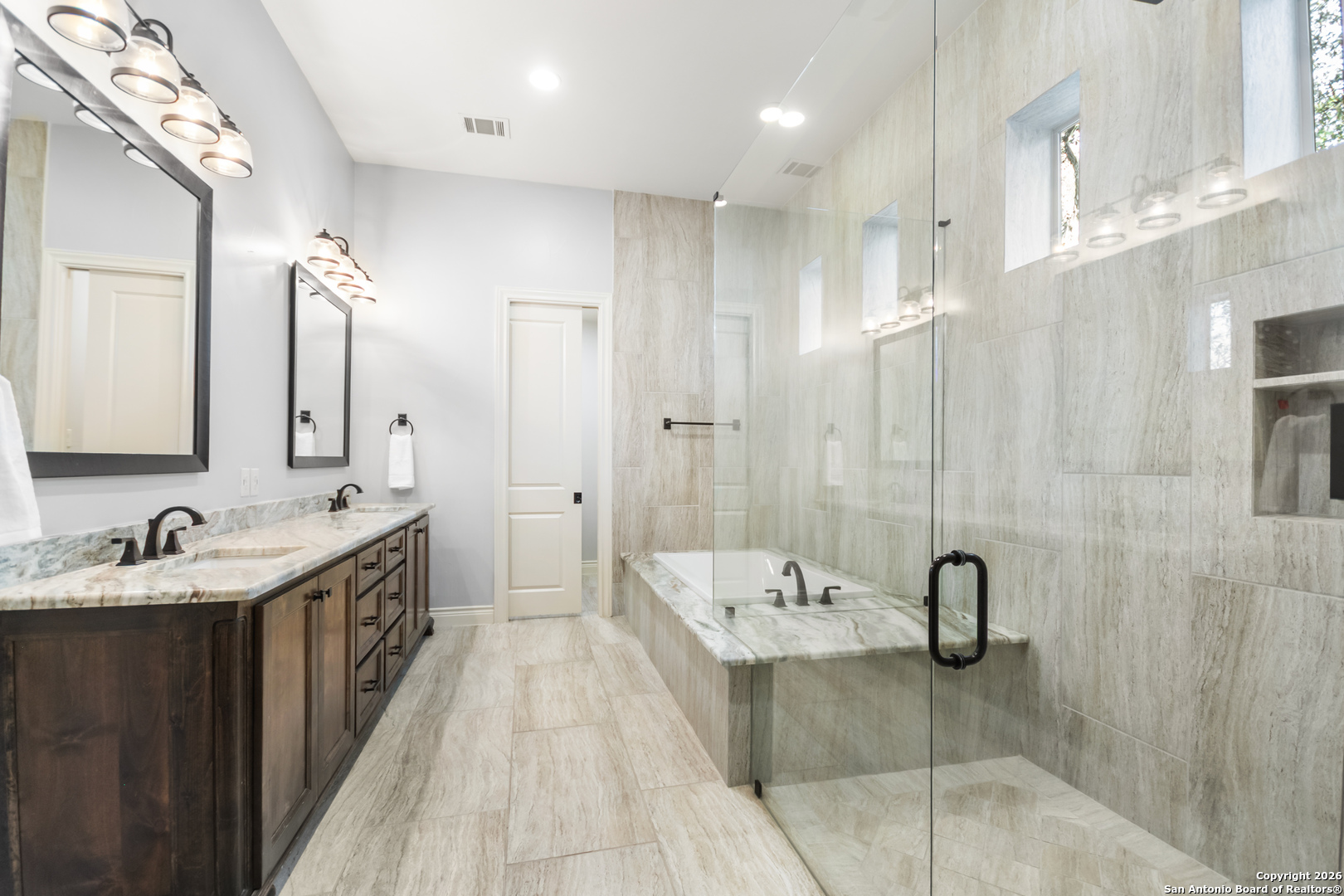 9 Ranch Brook Road Boerne, TX 78015 - Photo 24 of 59 a spacious bathroom with a double vanity sink a mirror and a shower