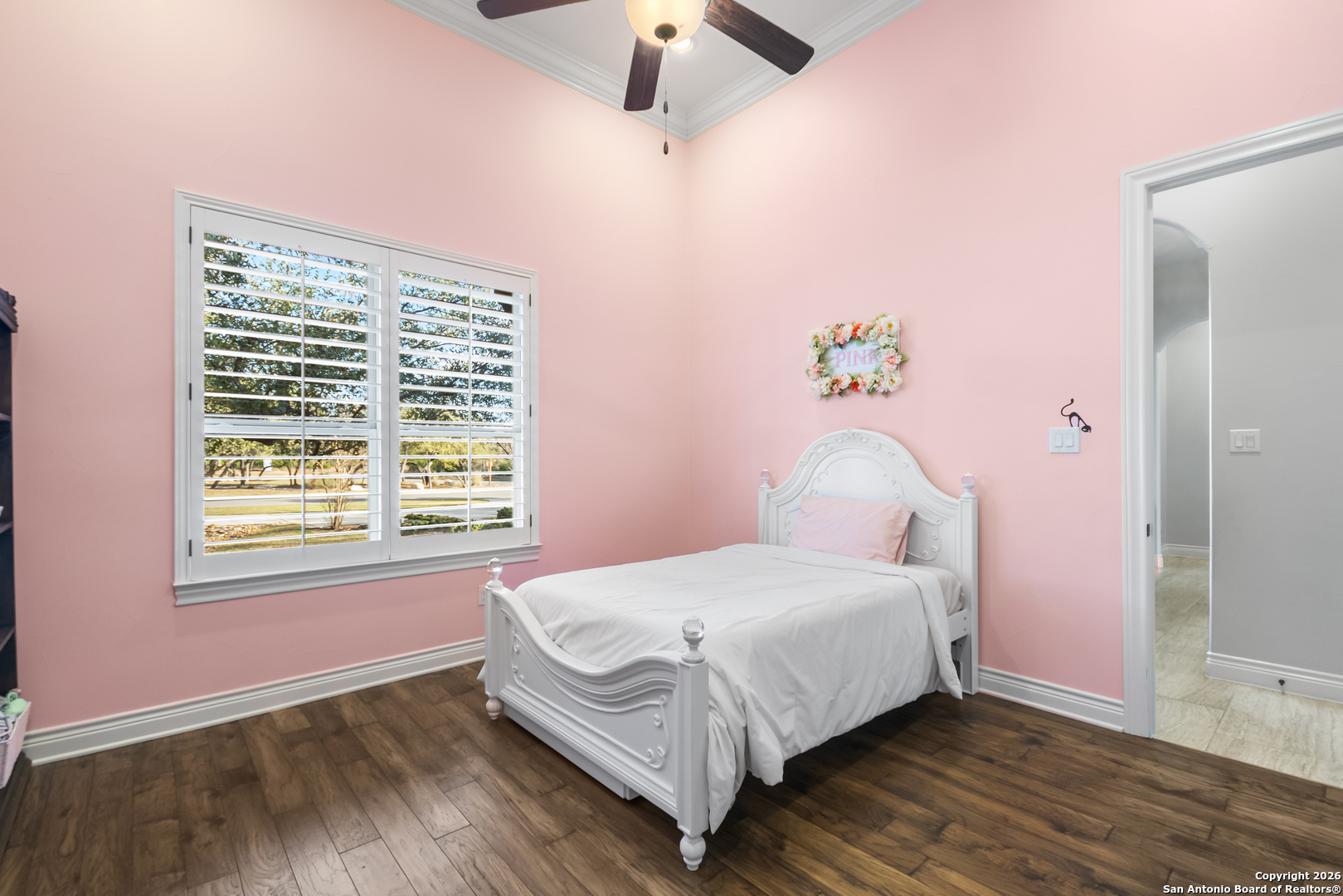 9 Ranch Brook Road Boerne, TX 78015 - Photo 25 of 59 a bedroom with a bed and a chandelier