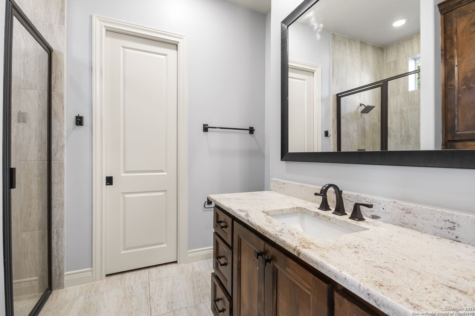 9 Ranch Brook Road Boerne, TX 78015 - Photo 28 of 59 a bathroom with a granite countertop sink and a mirror