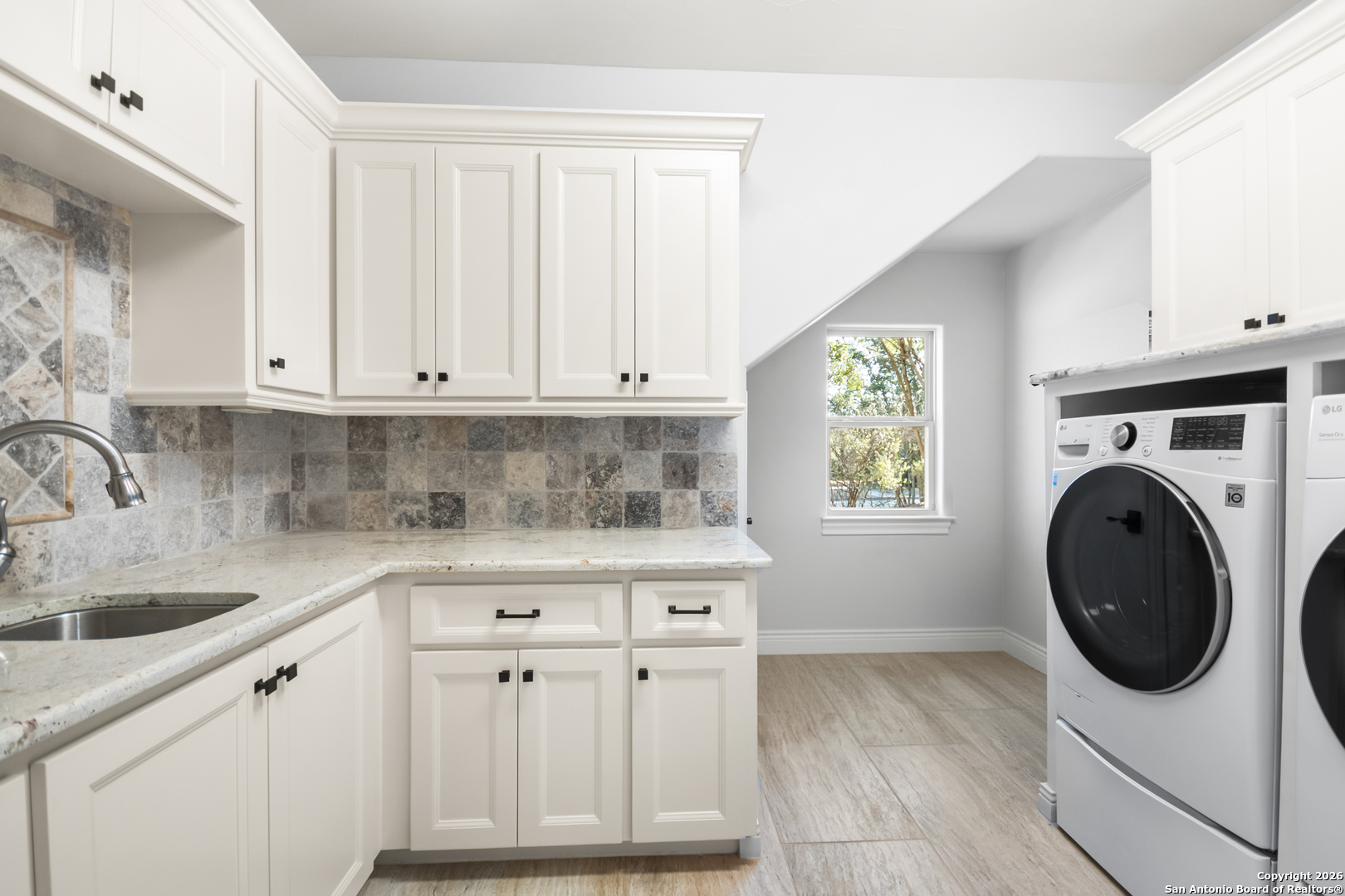 9 Ranch Brook Road Boerne, TX 78015 - Photo 32 of 59 a kitchen with stainless steel appliances white cabinets and a sink