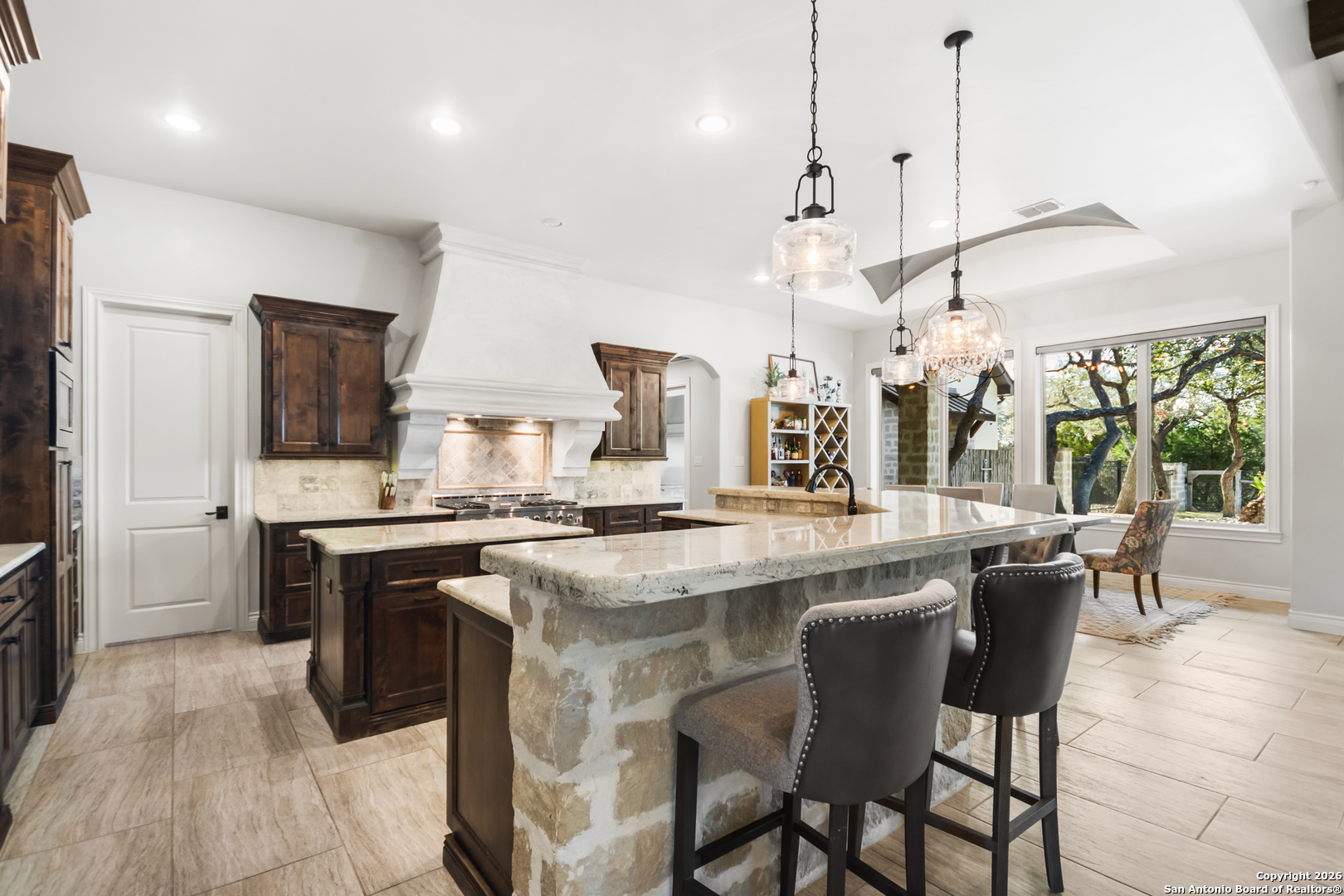 9 Ranch Brook Road Boerne, TX 78015 - Photo 9 of 59 a kitchen with stainless steel appliances granite countertop a stove and a view of living room