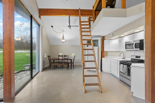 a view of a dining room with furniture window and outside view