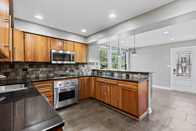 a view of a kitchen with a table and chairs in it