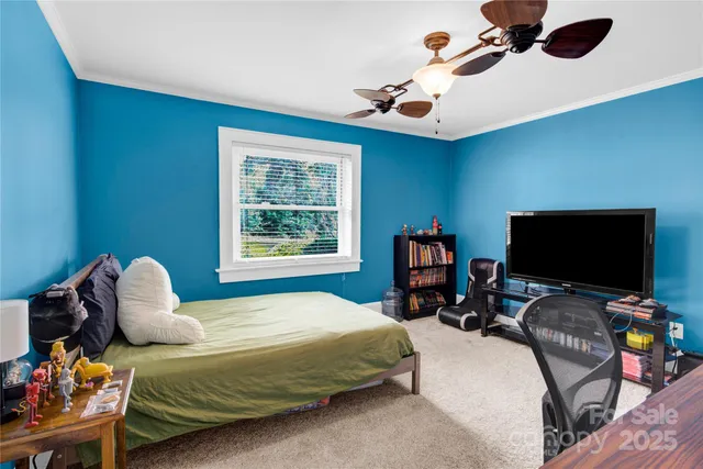 a bedroom with a bed and a tv