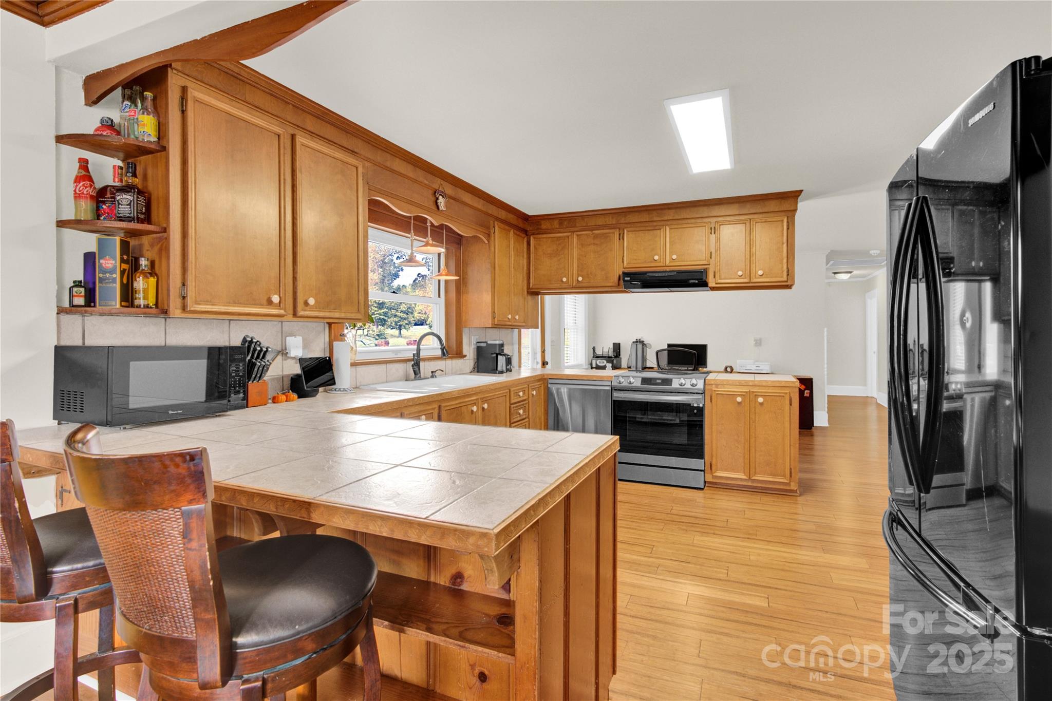 11720 Kluttz Road Gold Hill, NC 28071 - Photo 9 of 35 a kitchen with a stove a sink and a refrigerator