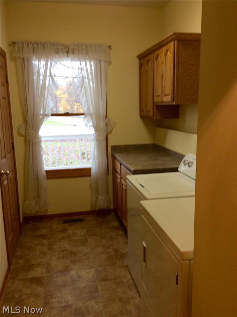 3400 Church Road Medina, OH 44256 - Photo 10 of 24 VERY EFFICIENT 1ST FLOOR LAUNDRY WITH PLENTY OF CABINET STORAGE, ALSO HAS INTERIOR STAIRWAY ACCESS TO THE BASEMENT.