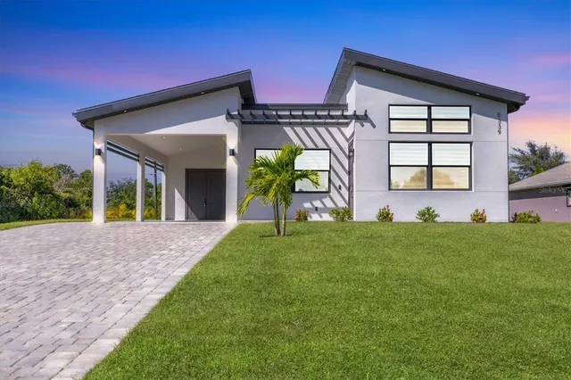 a view of a house with a small yard and a large window