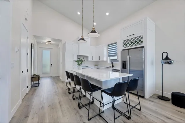a large kitchen with a table and chairs