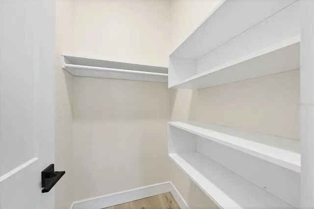 a view of walk in closet with empty racks