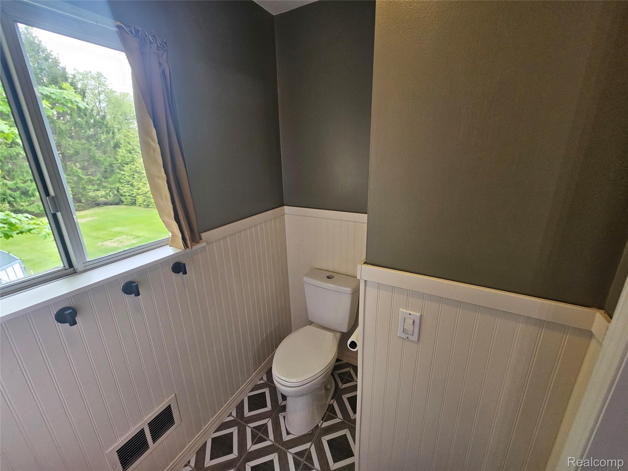 1210 Bay Ridge Drive Highland, MI 48356 - Photo 13 of 25 Bathroom featuring wainscoting and toilet