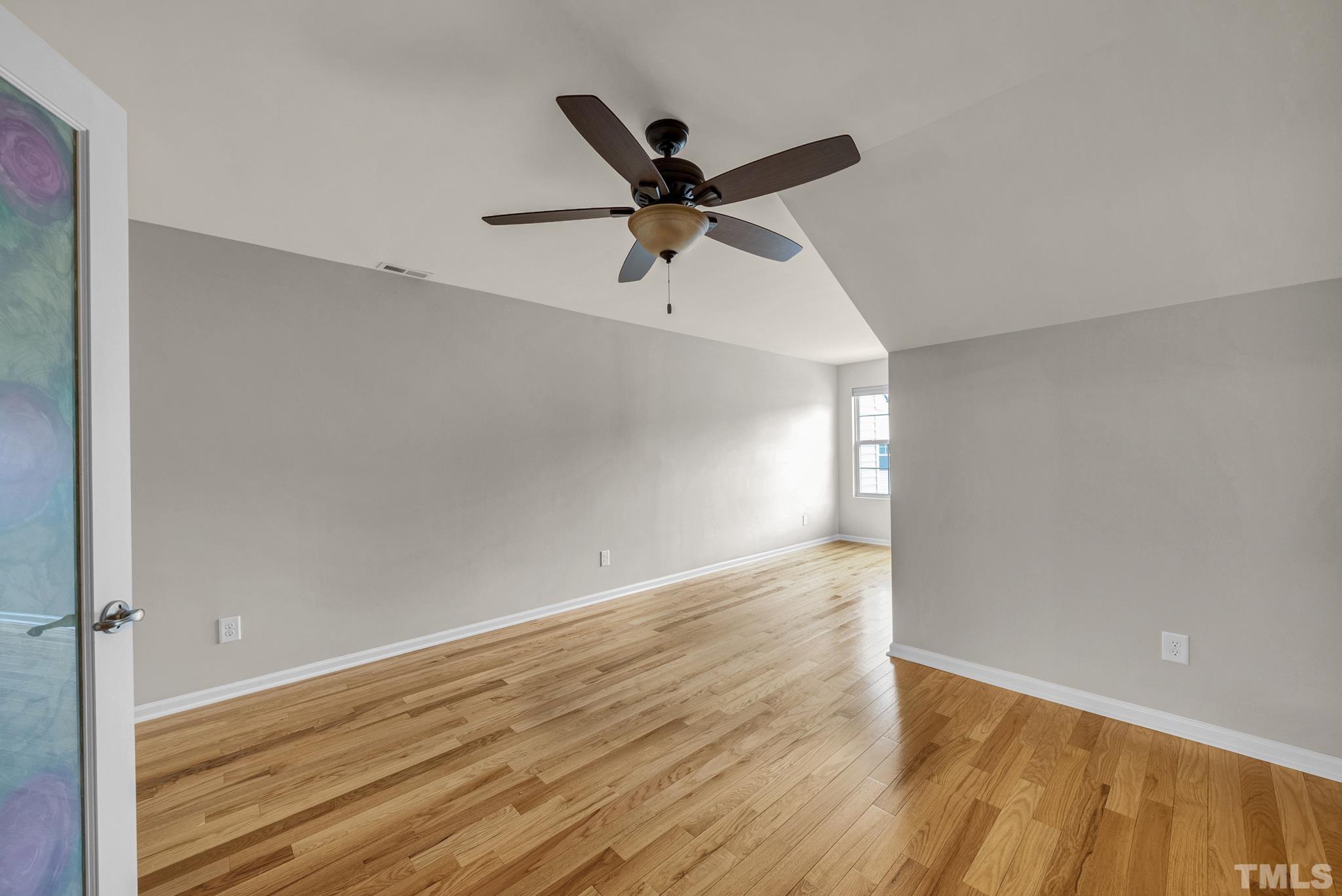 5 Intuition Circle Durham, NC 27705 - Photo 20 of 31 an empty room with wooden floor a ceiling fan and a ceiling fan