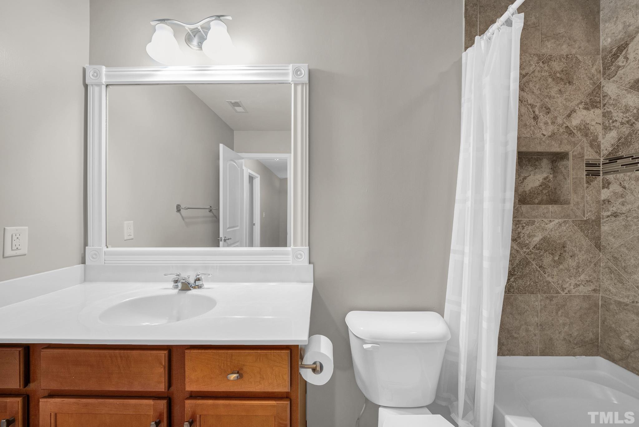 5 Intuition Circle Durham, NC 27705 - Photo 24 of 31 a bathroom with a sink a toilet and mirror