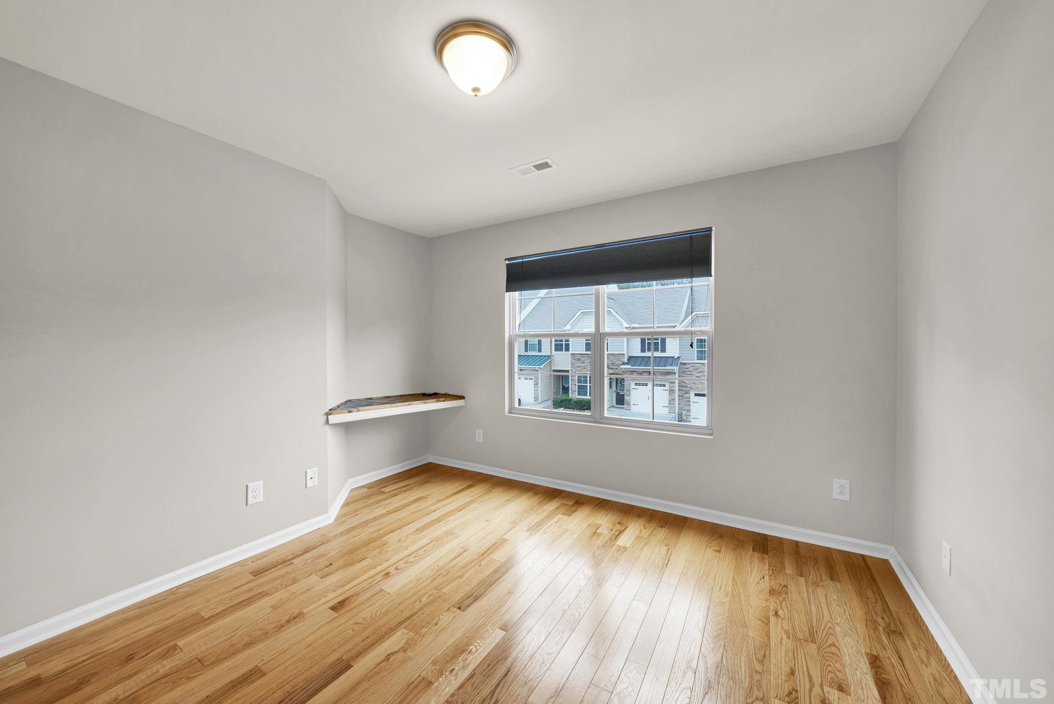 5 Intuition Circle Durham, NC 27705 - Photo 26 of 31 an empty room with wooden floor and windows