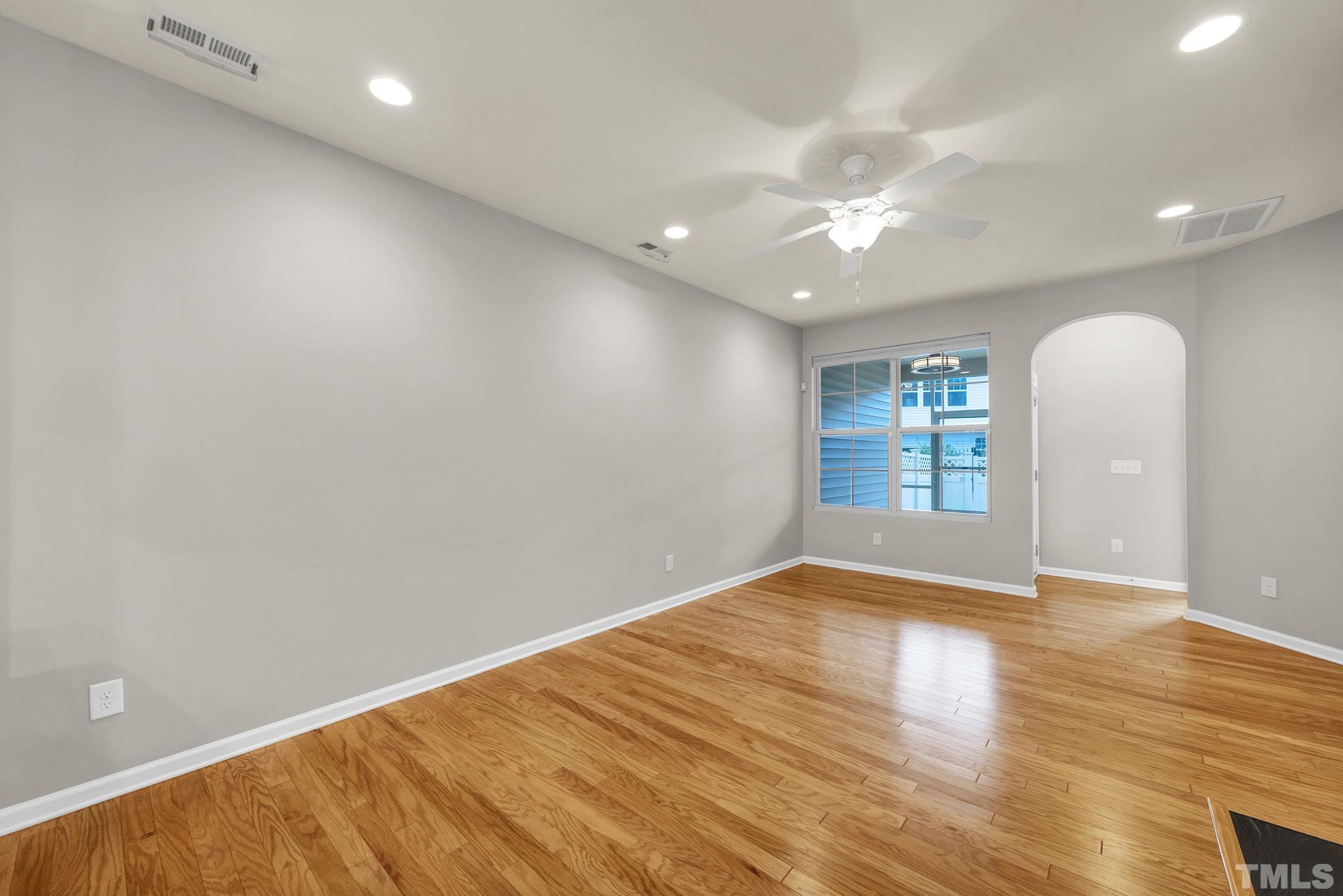 5 Intuition Circle Durham, NC 27705 - Photo 10 of 31 an empty room with wooden floor and windows