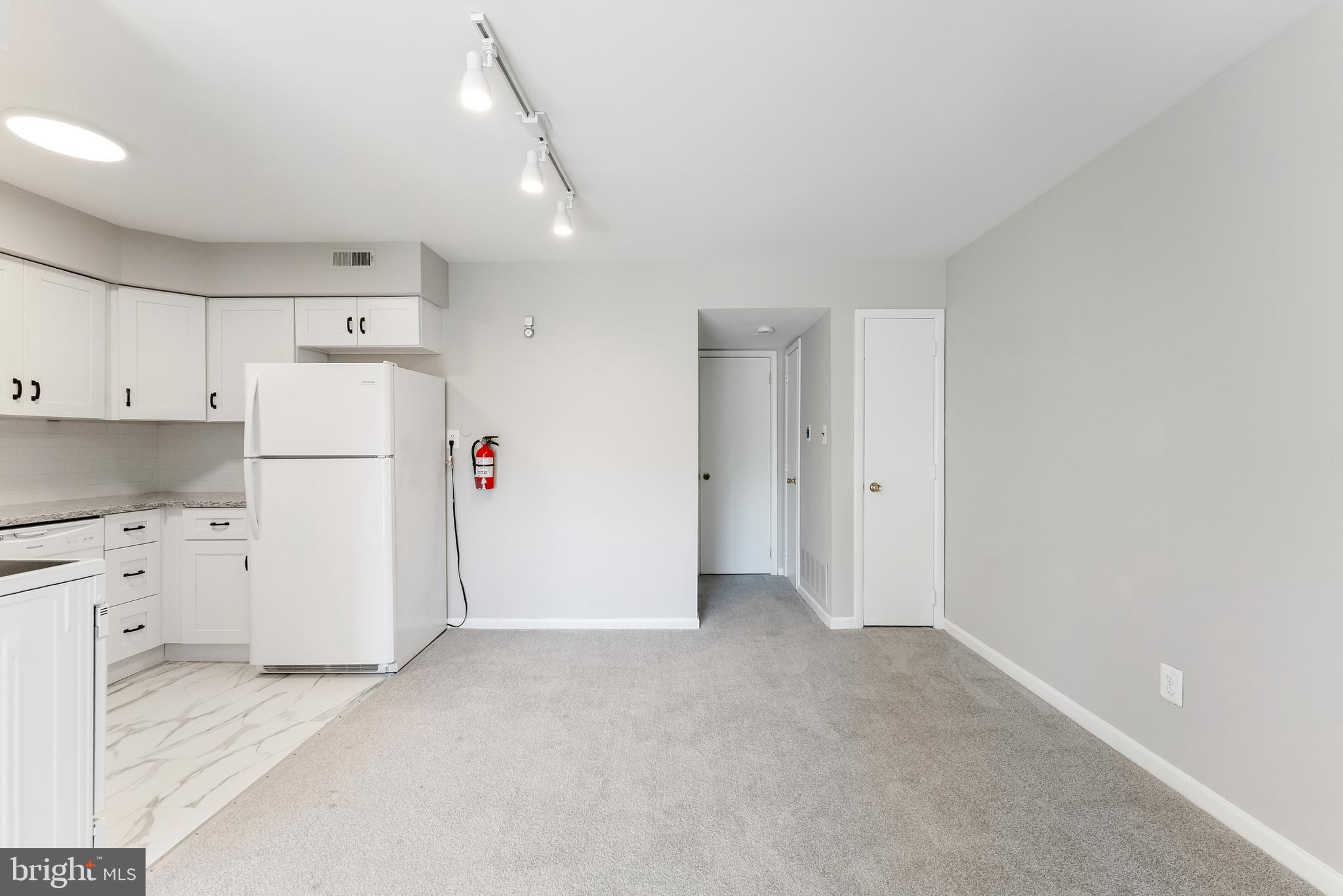 406 Winding Way Westville, NJ 08093 - Photo 11 of 20 a view of kitchen with refrigerator cabinets and wooden floor