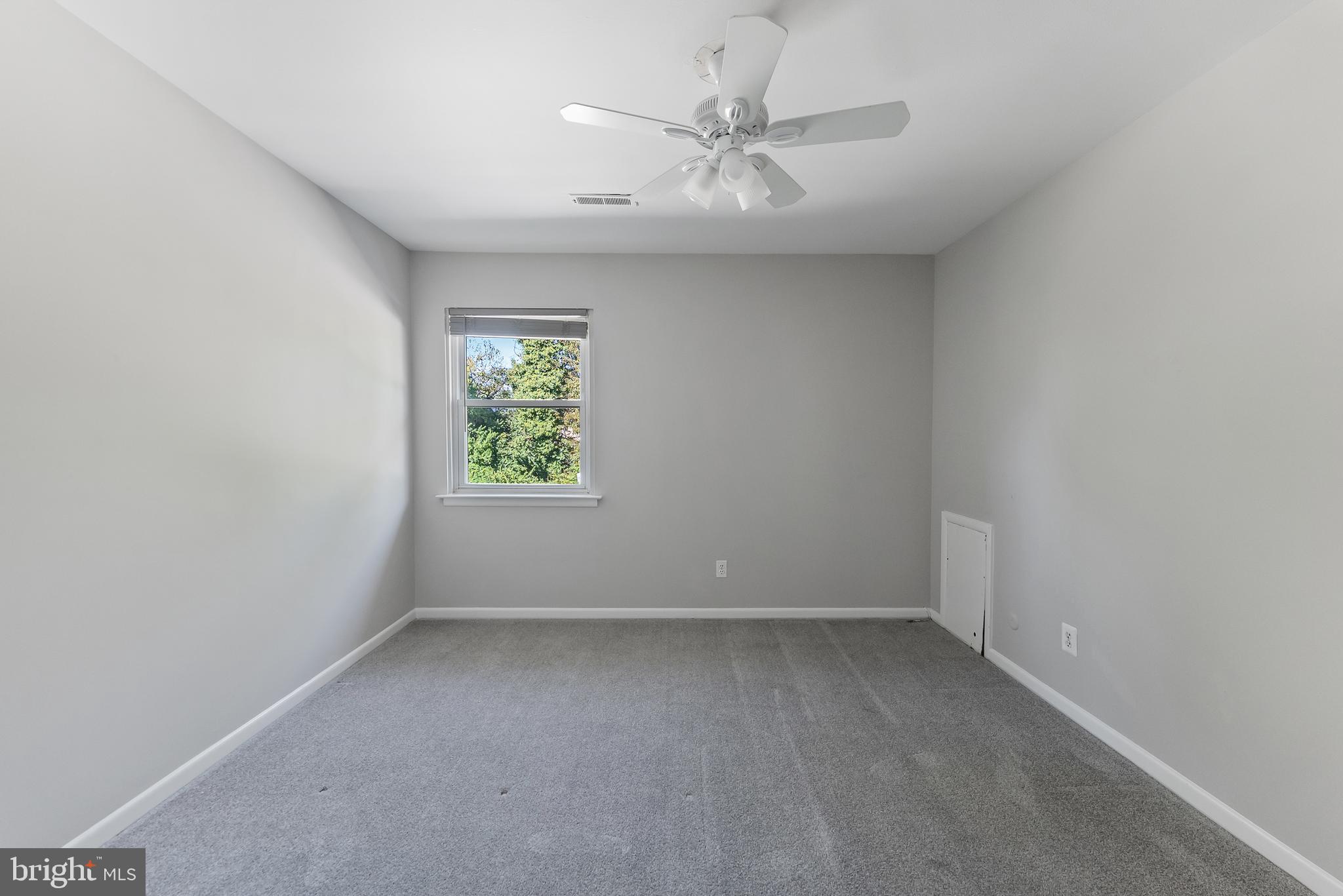 406 Winding Way Westville, NJ 08093 - Photo 13 of 20 an empty room with windows and fan