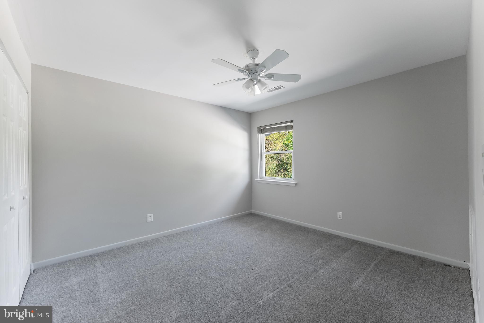 406 Winding Way Westville, NJ 08093 - Photo 14 of 20 an empty room with a window and a fan