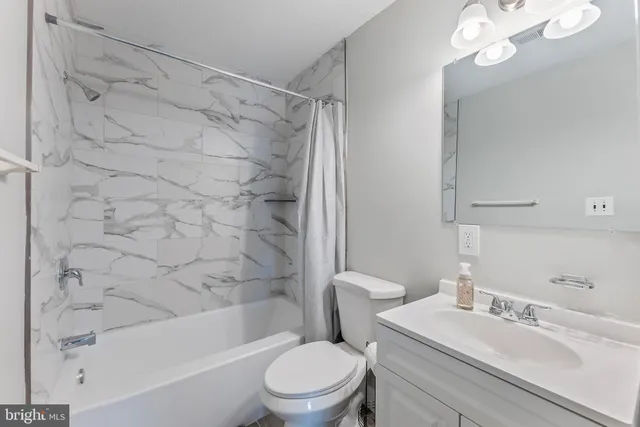 a bathroom with a sink a toilet and a bathtub