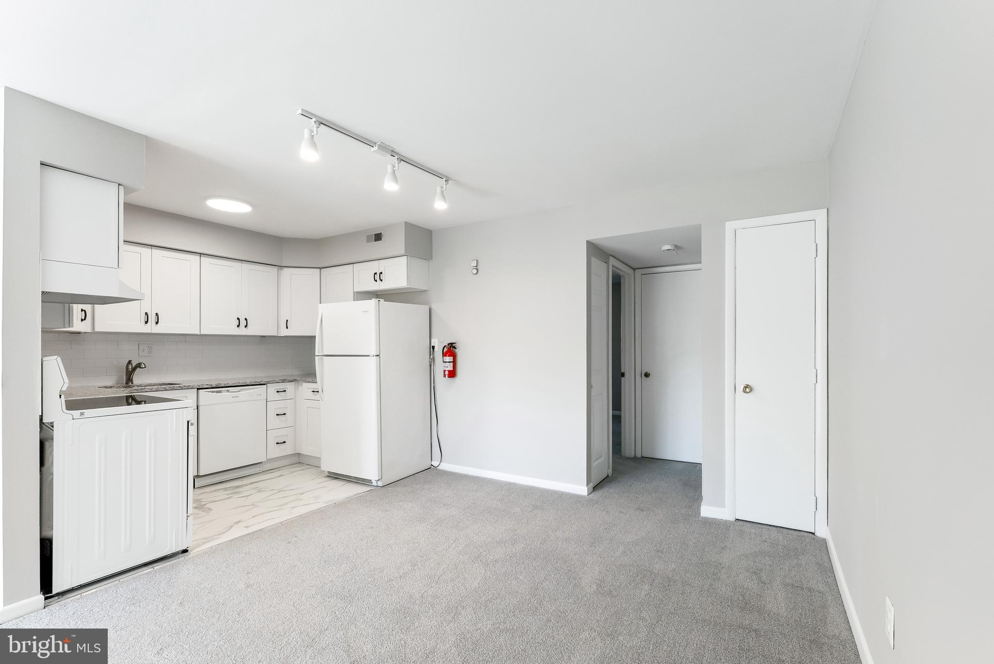 406 Winding Way Westville, NJ 08093 - Photo 9 of 20 a view of a kitchen with refrigerator and white cabinets