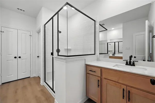 a bathroom with a double vanity sink and mirror