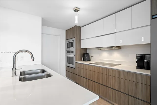 a kitchen with a sink and cabinets
