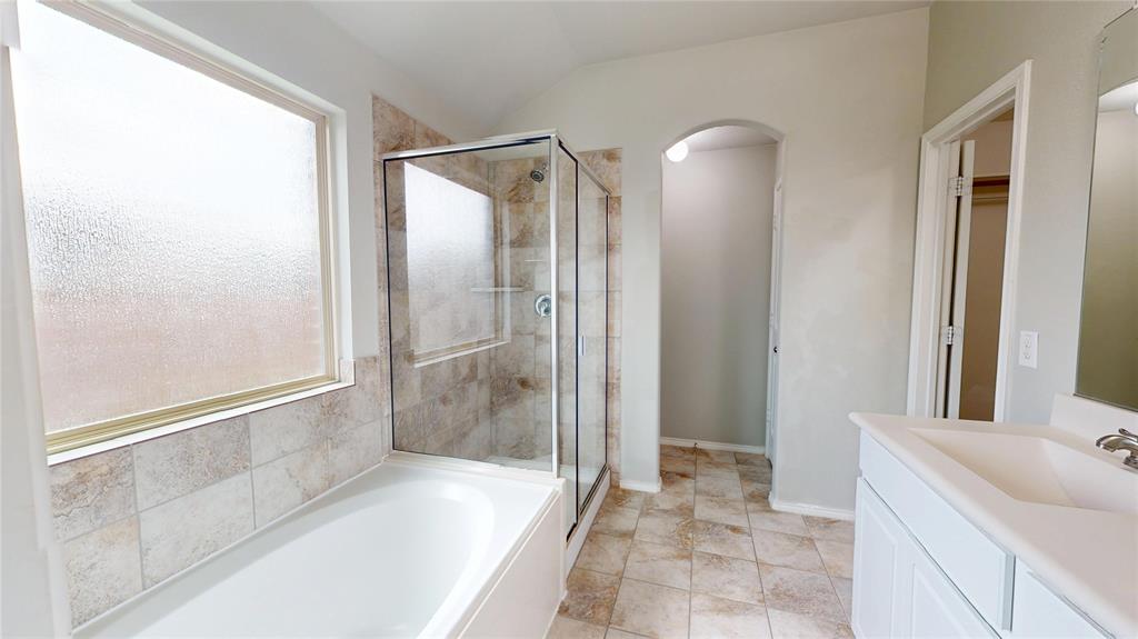 3101 Buckthorn Street Forney, TX 75126 - Photo 15 of 40 Bathroom featuring a combination shower and bathtub with tile surround, glass shower enclosure, and a frosted privacy window
